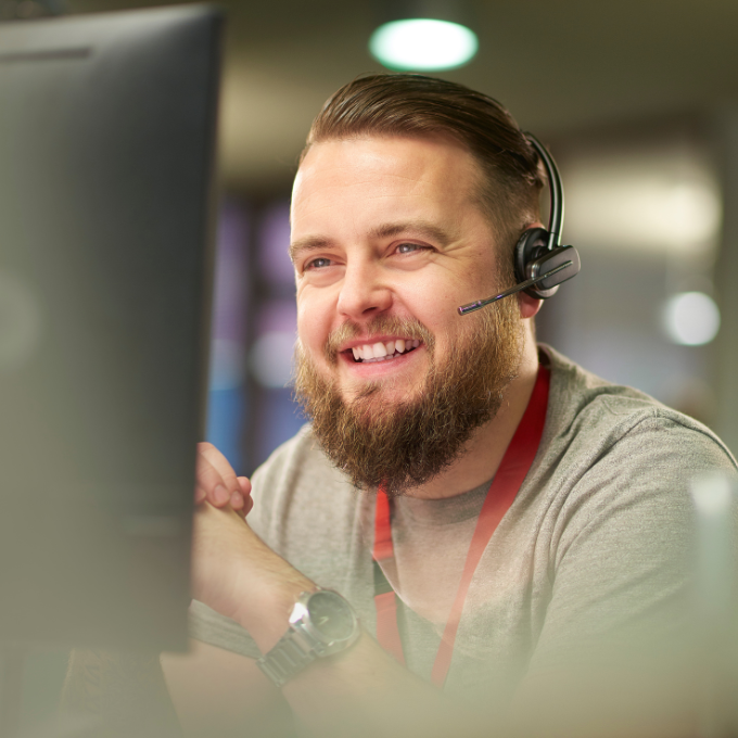 A man in a headset speaking on the phone, representing managed services and customer support.