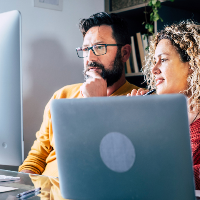 Two people looking at a computer screen