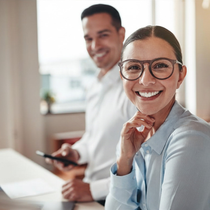 Businesswoman smiling while working with a colleague in an office