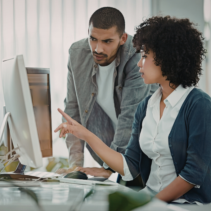 Two people looking at a computer screen together
